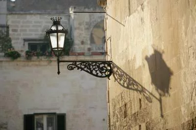 odd street lamp shadow in sunny florence