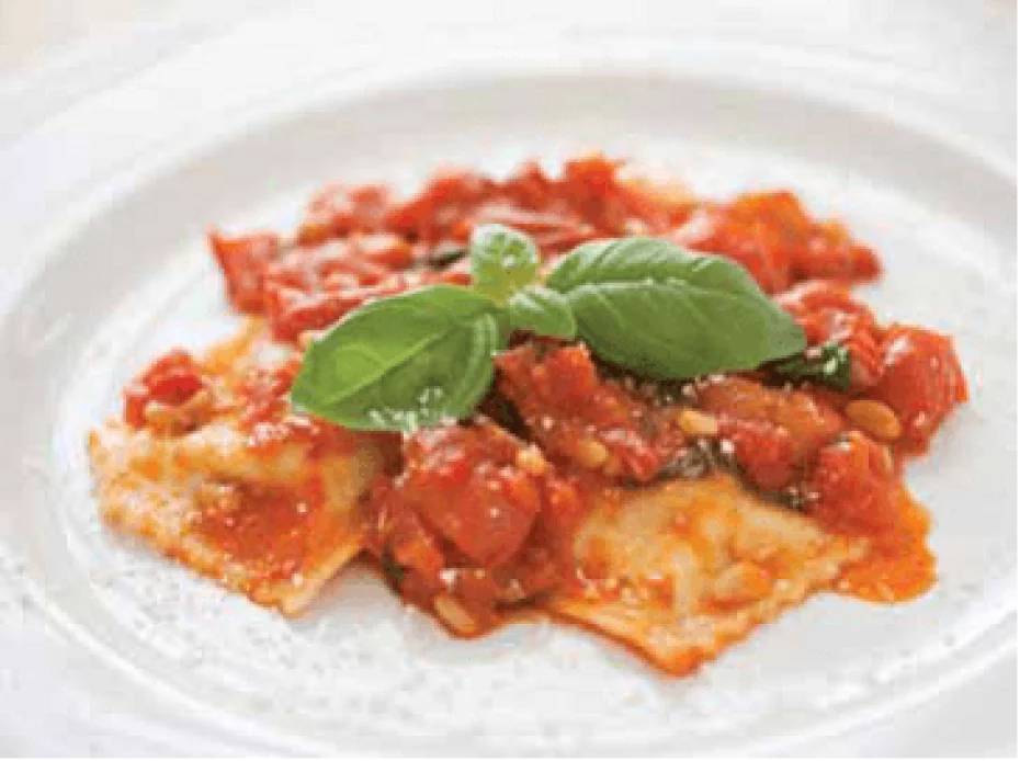 Ravioli di Ricotta, in a tomato sauce on a white plate