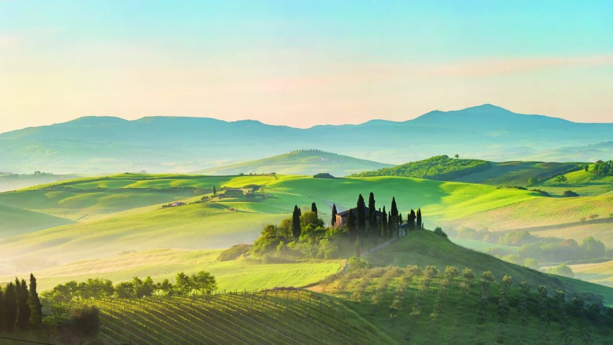 View across foggy rolling hills in Tuscany