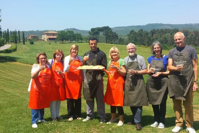 Cooking group pose with their pasta in Italy